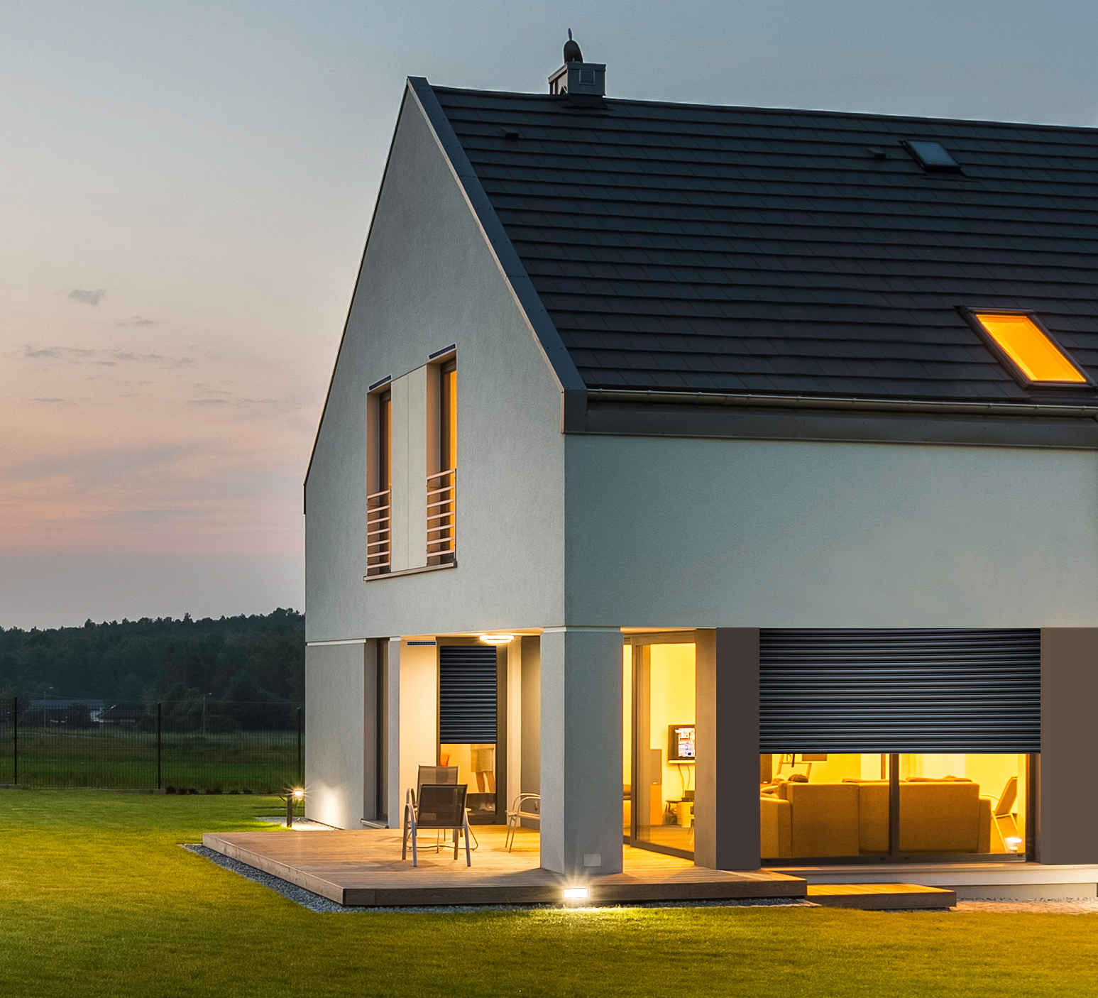 Panoramic photo of modern house with outdoor and indoor lighting, at night